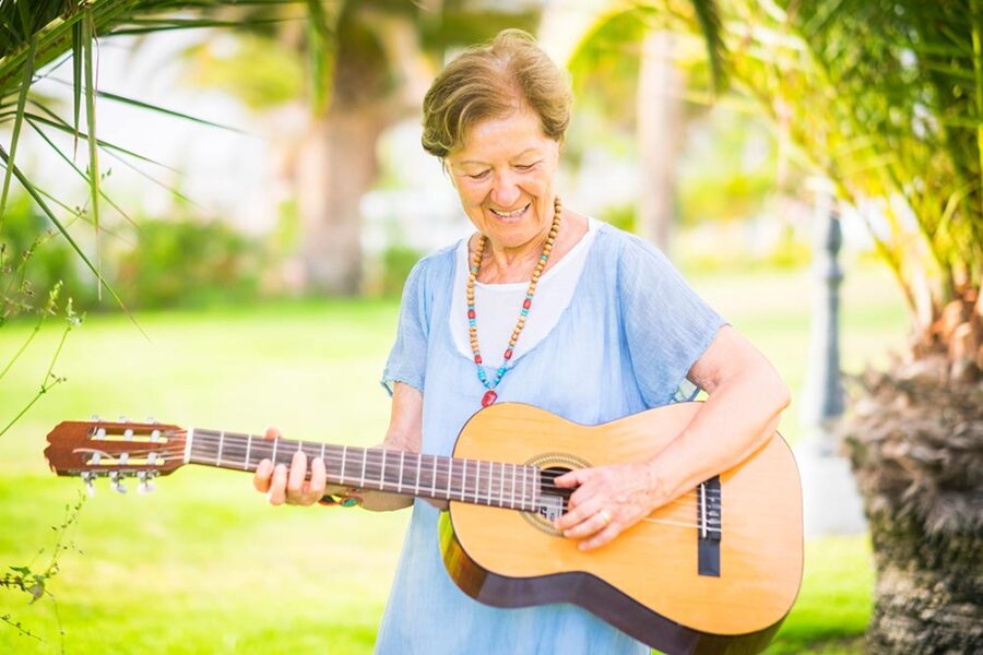 Older woman playing the guitar