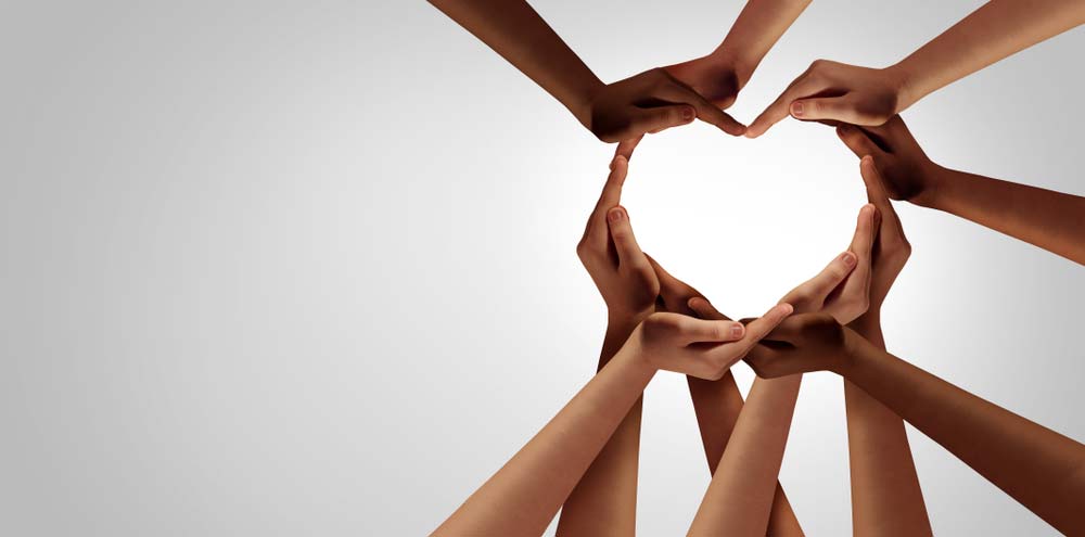 A bunch of hands coming together to form a heart