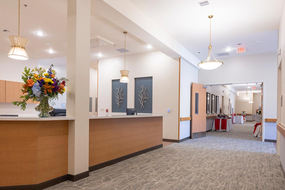 San Antonio Hospice House front desk with logo and plants