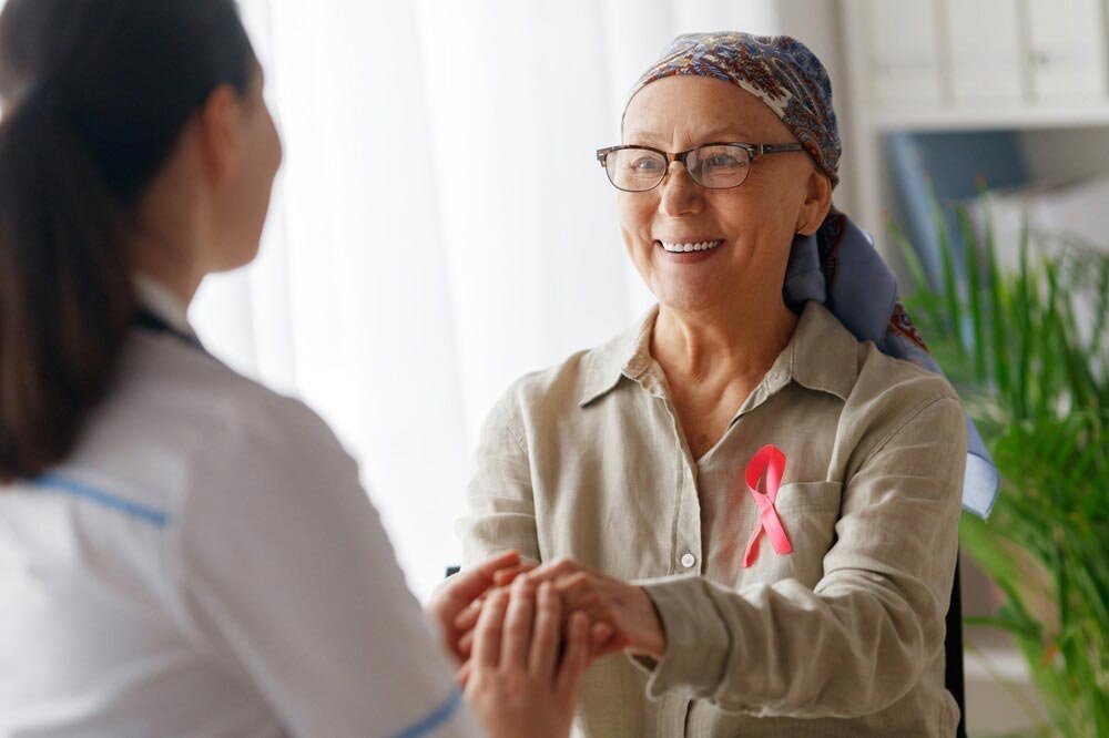 A woman with breast cancer being comforted