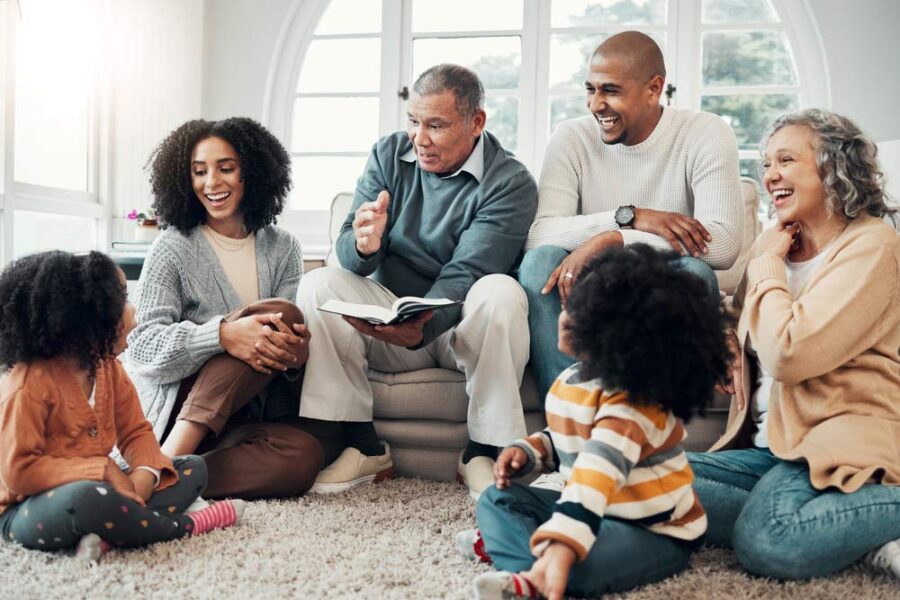 A family gathered in a living room hearing a story