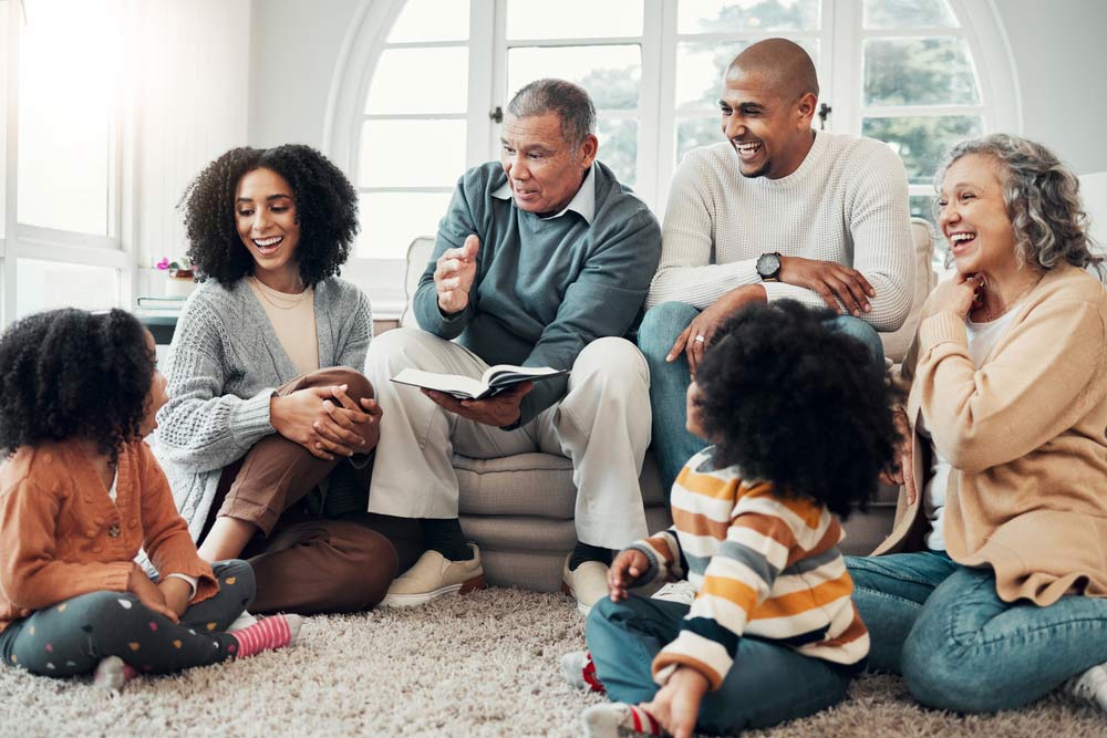 A family gathered in a living room hearing a story