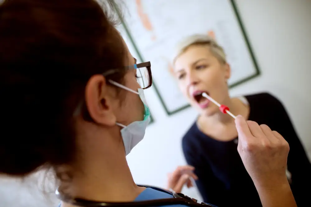 A woman getting a genetic swap of her mouth done